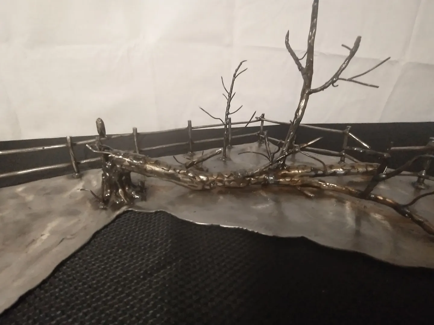 A tree branch is shown in the middle of a room.