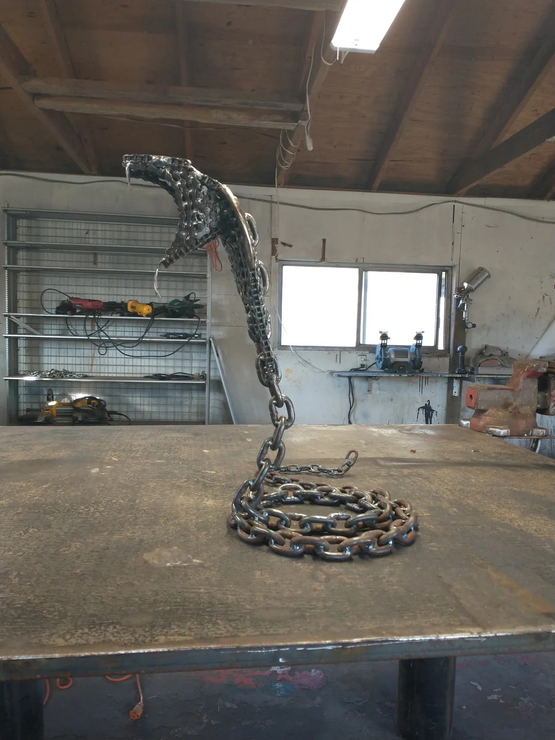 A metal snake sitting on top of a table.