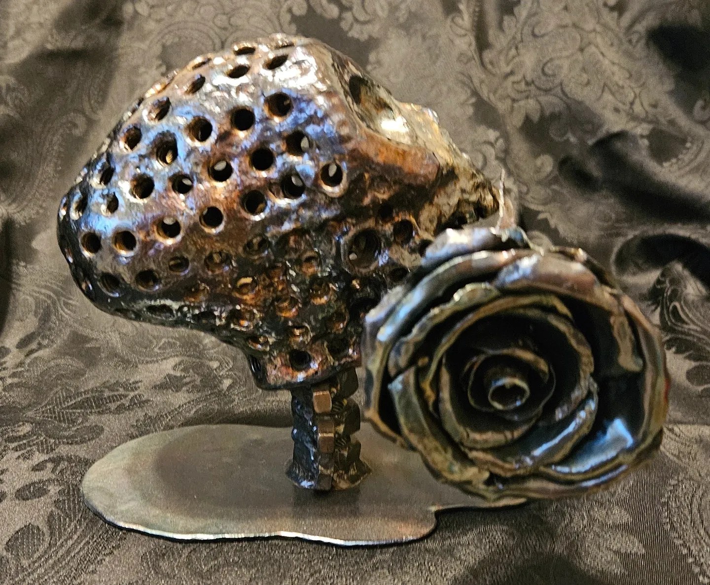 A metal sculpture of a flower and its petals.