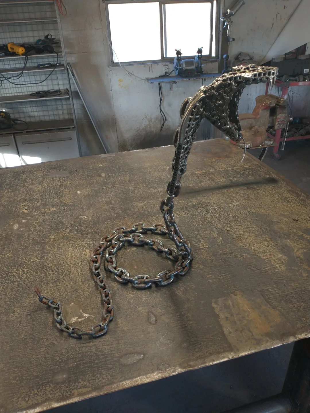 A snake made of chains sitting on top of a table.