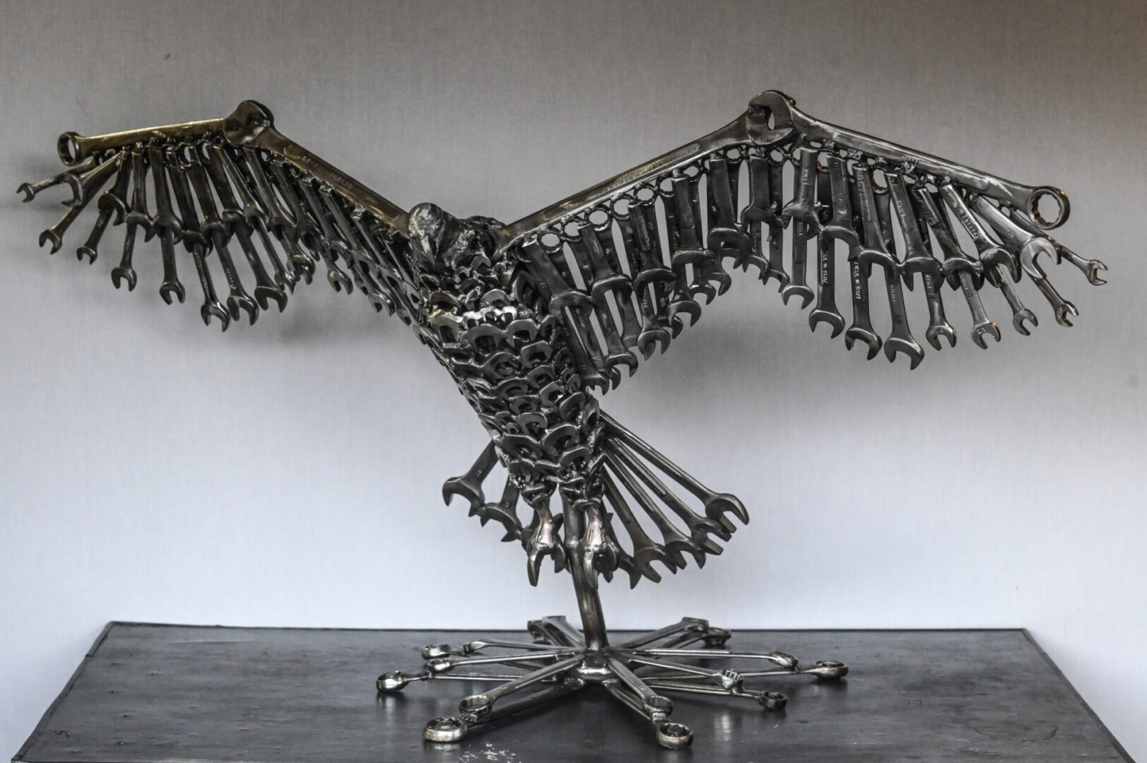 A metal sculpture of an eagle made out of bicycle parts.