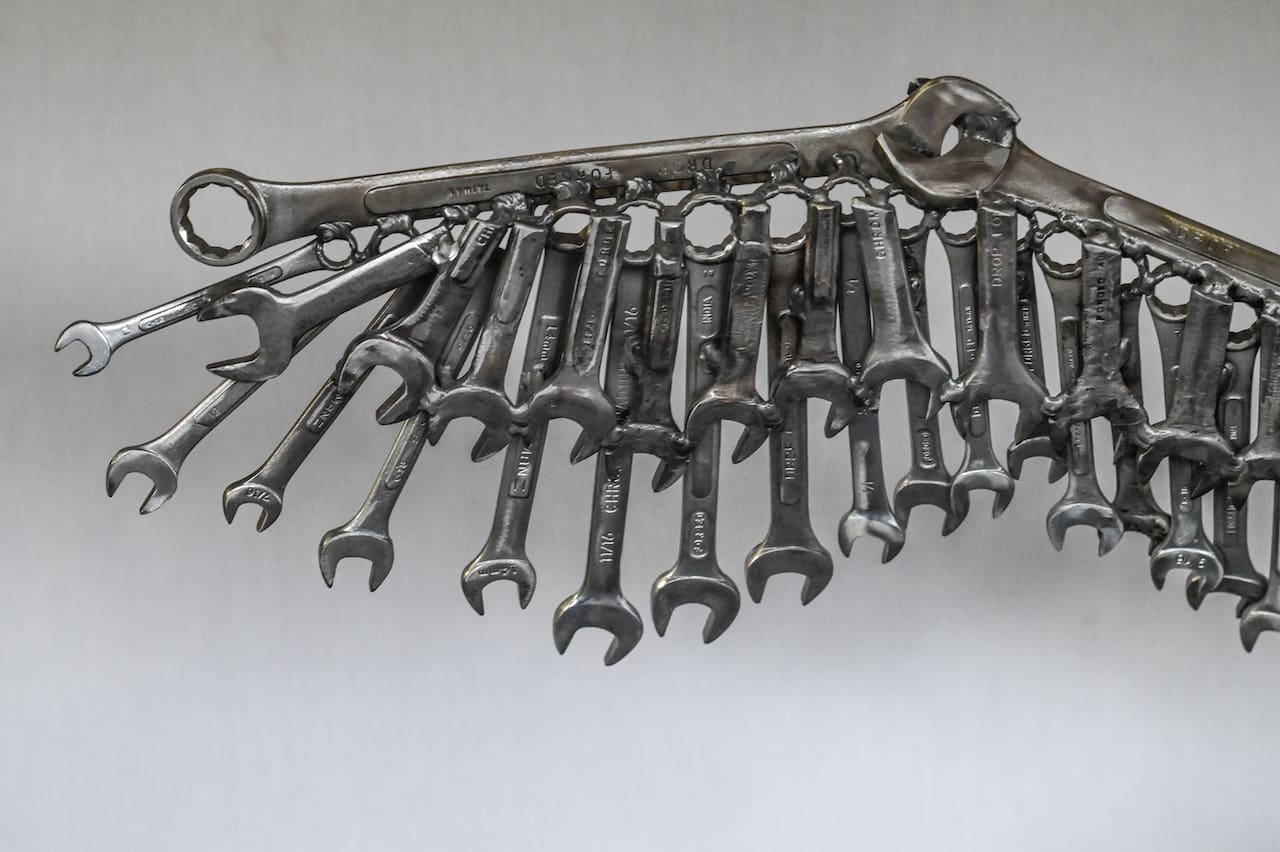 A bunch of wrenches hanging on the wall