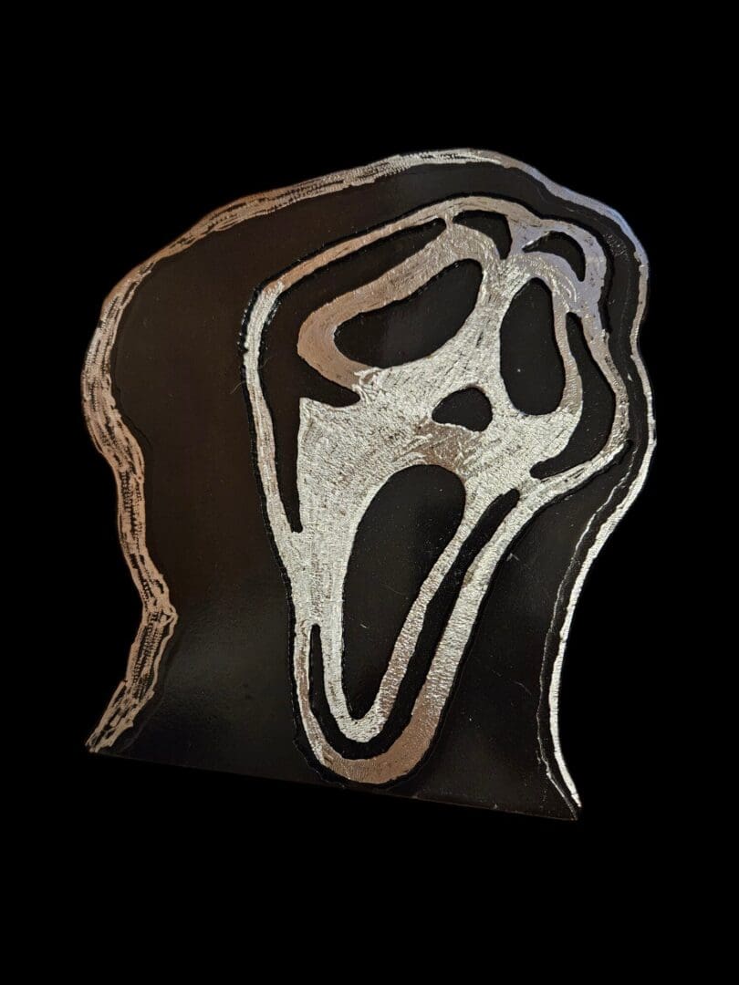 Silver Scream Ghostface mask cutout.