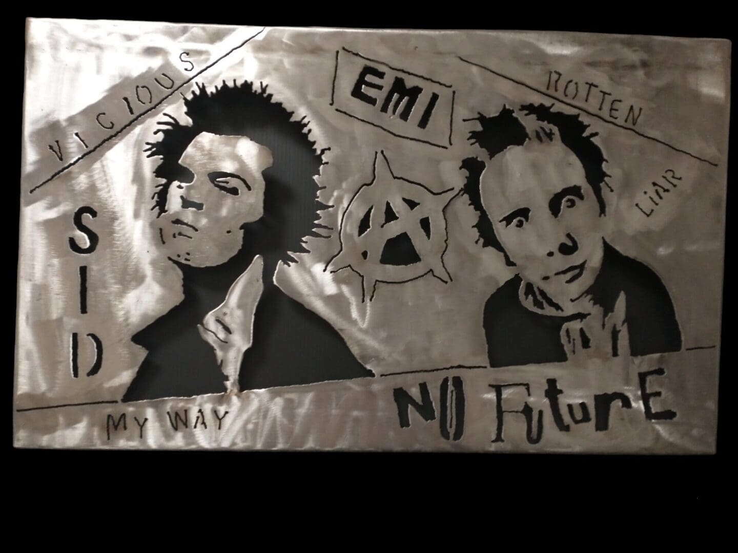 Metal cutouts of Sid Vicious and Johnny Rotten.