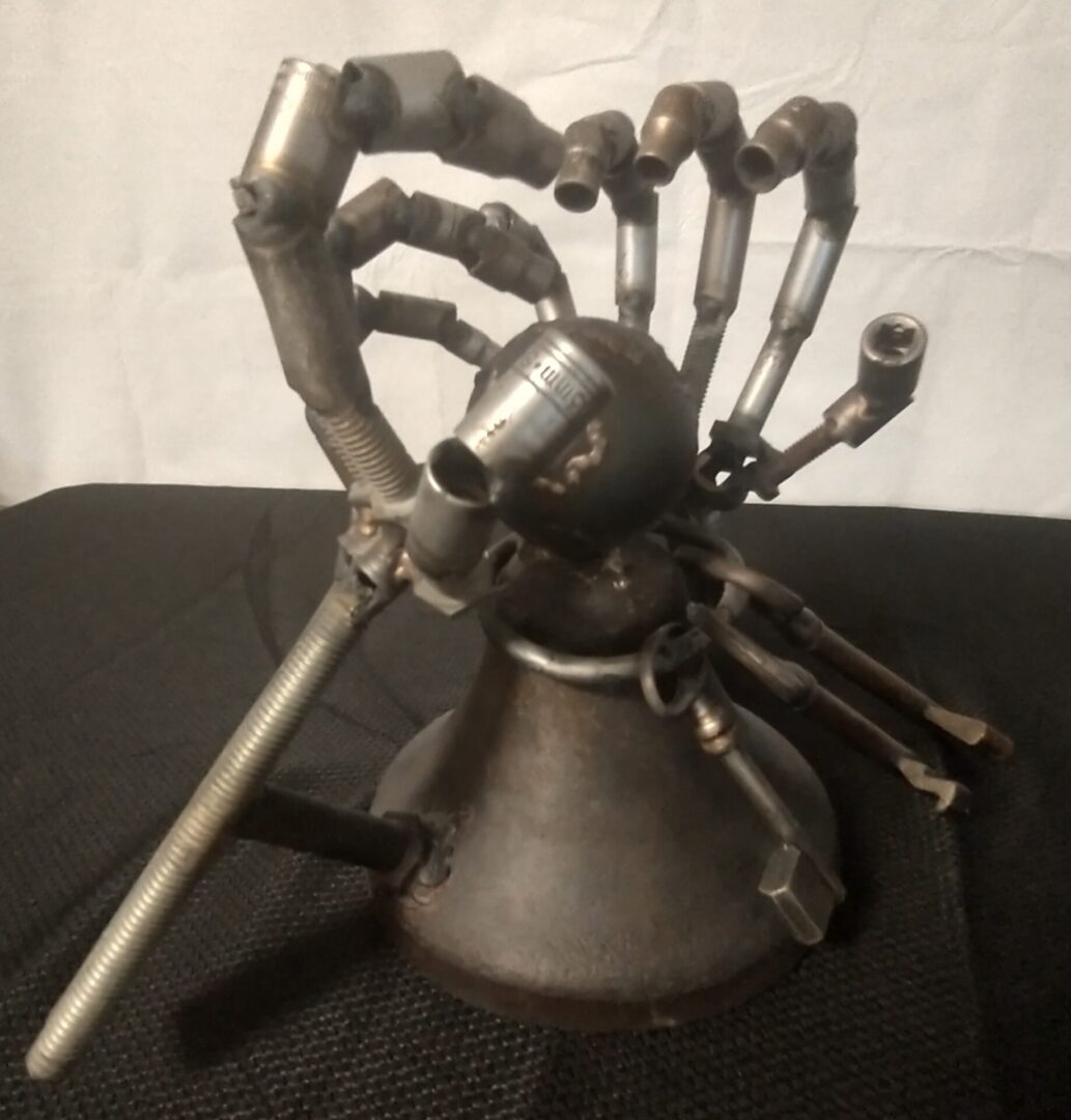 A metal sculpture of an octopus with many arms.