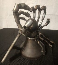 A metal sculpture of an arm and hand.