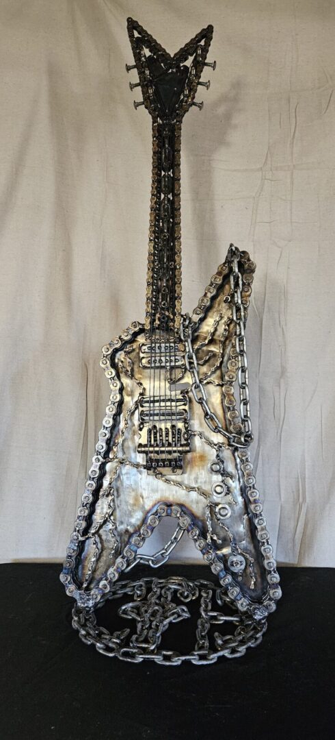 Metal guitar sculpture made of chains.