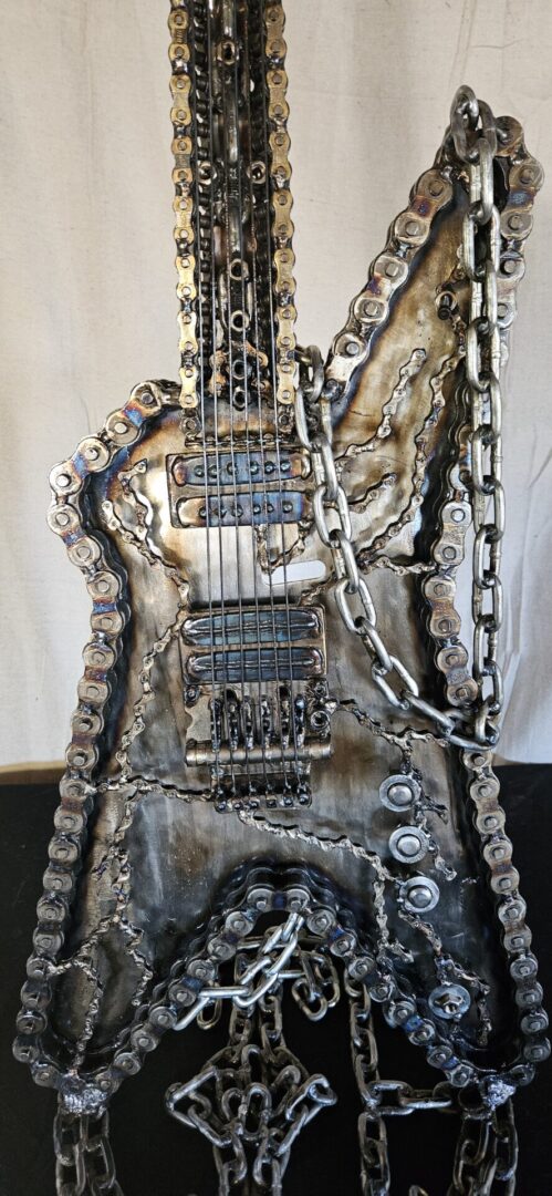 Metal guitar sculpture made from chains.