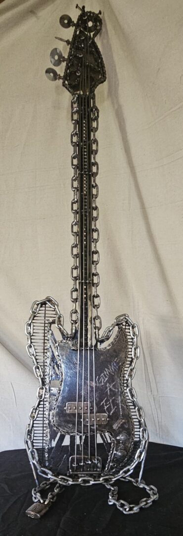 Metal chain bass guitar sculpture.